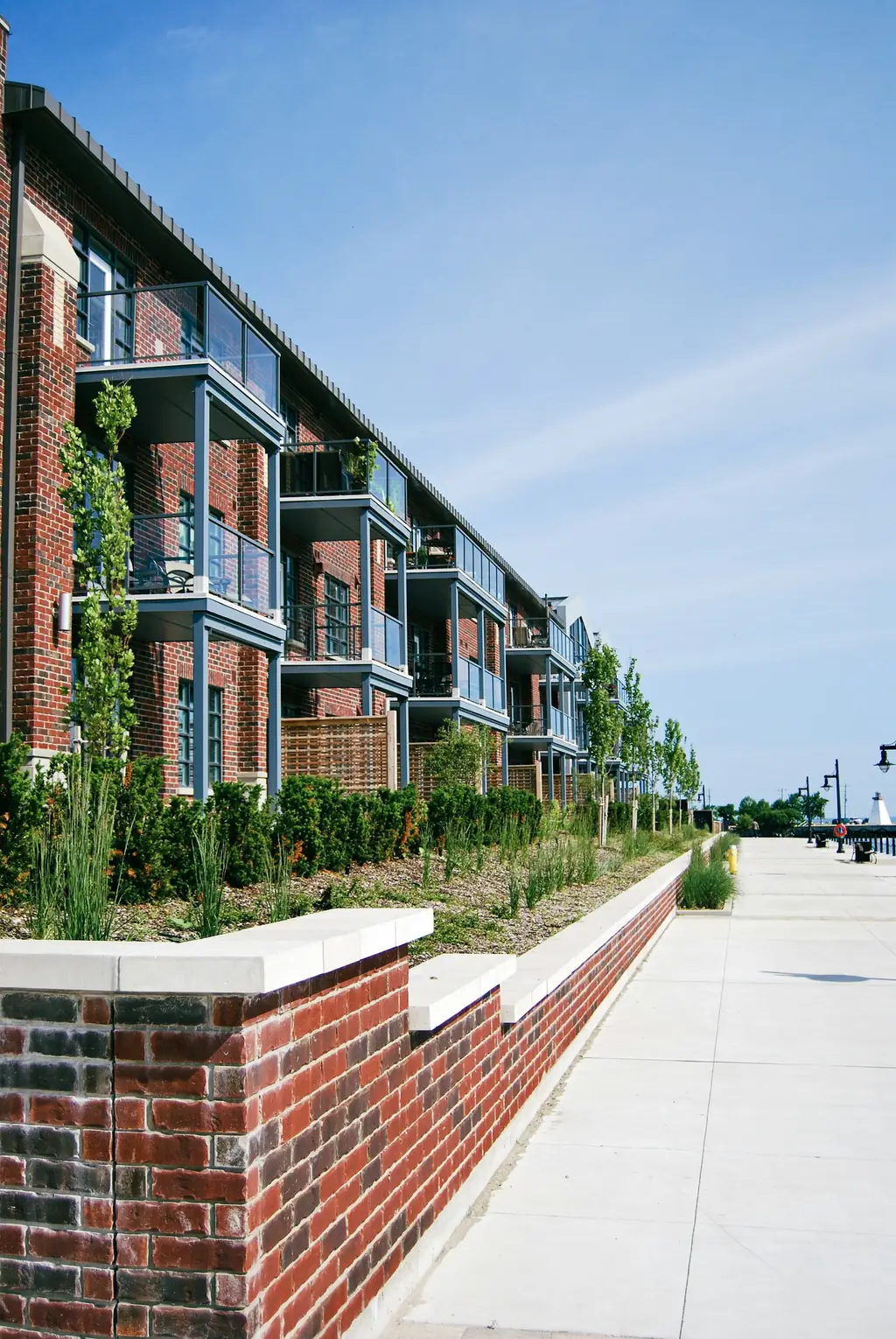 Red brick multifamily apartment building with balconies in the Kansas City area