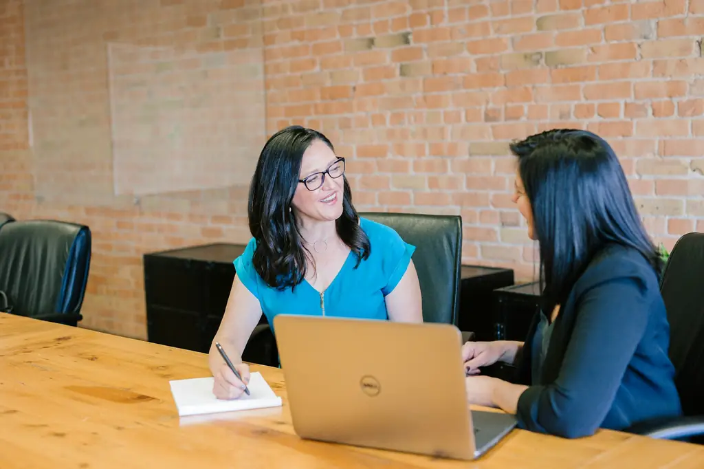 Property owner reviewing a management plan with a Stalwart team member at a table