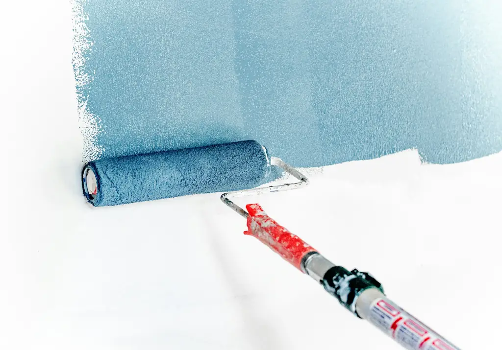 Painter refreshing a wall between tenants